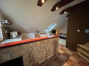 a kitchen with a sink and a counter top at Solar Apartman in Vonyarcvashegy