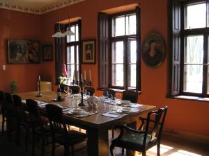 a dining room with a table with wine glasses at Dwór Bieganów in Bieganów
