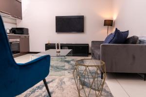 a living room with a couch and a table at Fully furnished apartment. in Sandton