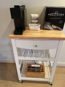 a white table with a box on top of it at Glenelg resort style beachside apartment in Glenelg