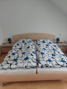 a couch with blue and white pillows on it at Haus Jezek in Windischgarsten