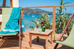 a patio with two chairs and a table with a bottle of champagne at Akwabay - Les Villas du Cap in Le Lavandou