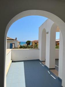 an archway in a building with a view of the ocean at Archiammare Sea in San Lorenzo