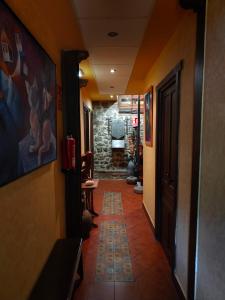 a hallway with a tile floor in a building at Hotel Doña Gaudiosa in Pola de Lena