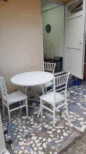 a table and two chairs and a white table and chairs at Eka's Vacation House in Batumi