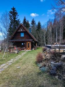 a large wooden house in the middle of a field at Boutique Chalet - Herke in Eitweg