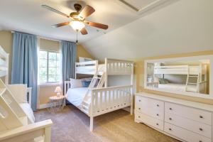 a bedroom with bunk beds and a ceiling fan at Spacious Utah Retreat with Deck, Grill and Fire Pit! in Provo