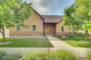 a yellow house with a landscaping at Spacious Utah Retreat with Deck, Grill and Fire Pit! in Provo