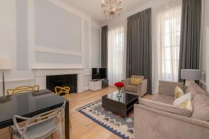 a living room with a couch and a fireplace at 17 Hertford Street in London