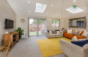 a living room with a couch and a tv at Hollis House York- 4 bedroom with free parking in Strensall
