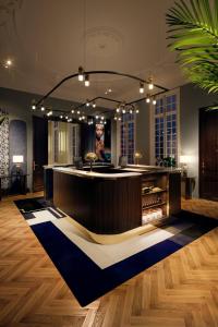 un vestíbulo con un bar con una alfombra azul y blanca en Sapphire House Antwerp, Autograph Collection, en Amberes