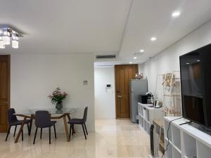 a kitchen and dining room with a table and chairs at Putney Studio, short drive to parklands & Olympic Park in Sydney