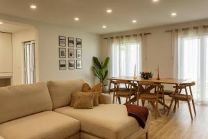 a living room with a couch and a table at Nōhō house in Carrapateira