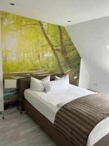 a bedroom with a bed with a large window at Hochwald Lodge in Morbach