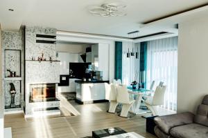 a living room with a fireplace and a table and chairs at Casa DIAMOND LUX&SPA in Sovata