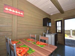 a kitchen with a wooden table with peppers on it at Cottage in Cisowo near Baltic Coast Beach in Cisowo