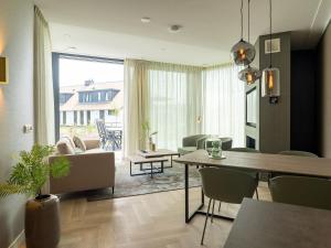 a living room with a table and chairs and a dining room at Villa in Texel near De Koog Beach in De Koog