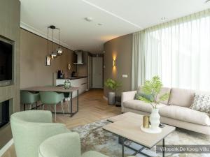 a living room with a couch and a table at Villa in Texel near De Koog Beach in De Koog