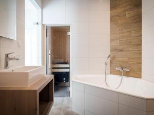 a bathroom with a sink and a bath tub at Villa in Texel near De Koog Beach in De Koog +34 photos