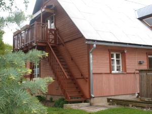 a house with a staircase on the side of it at Omakoda in Vanamõisa