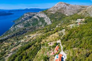 an aerial view of a mountain with a village on it at Amber's Place: cosy house with pool and sea views in Dubravica