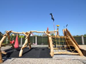 a playground with a swing set in a park at Tranquil Baltic Escape in Cisowo