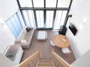 una vista aérea de un loft con mesa y sillas en Modern design lodge with combi microwave, in national park en Tholen