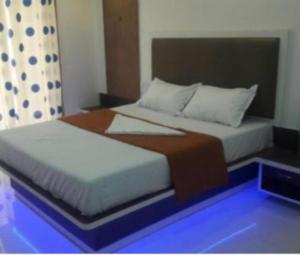 a bedroom with a large bed with a blue at Royal Heritage in Mahabaleshwar