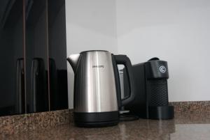 a coffee maker sitting on top of a counter at Aguieira STAY in Castro Daire