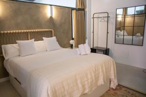 a bedroom with a large white bed with white pillows at Elegant and luxurious apartment in Madrid PDD5 in Madrid