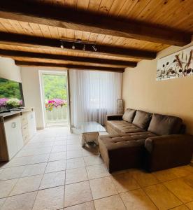 a living room with a couch and a television at Hotel St. Georg in Ediger-Eller