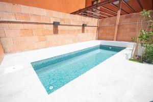 a swimming pool with a tile floor and a brick wall at Elegant and luxurious apartment in Madrid PDD5 in Madrid