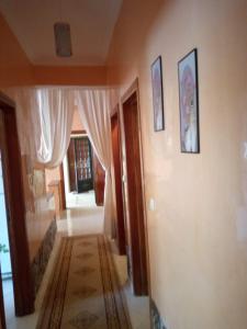 a hallway of a home with curtains and a room with a rug at Appartement agadir in Agadir