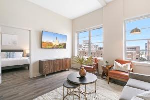 a living room with a bed and a couch at Spacious 4B Oasis steps from French Quarter - Your NOLA Dream Awaits! in New Orleans