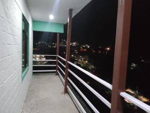 a balcony with a view of the city at night at Badrinath Jb Laxmi hotel in Badrīnāth