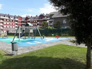a park with a playground with a swing at Piso Al Norte in Treto