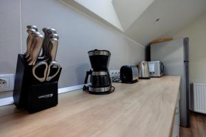 a kitchen counter with a coffee maker and a blender at Casa Pricop Moroșană in Vadu Izei