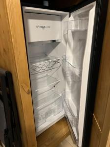 an open refrigerator with its door open and its shelves at Les Camparoles in Font Romeu Odeillo Via