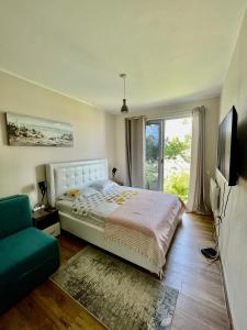 a bedroom with a bed and a large window at Glass house in Ulcinj