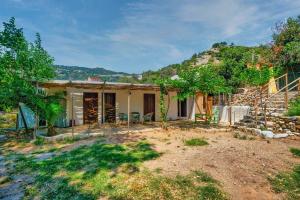 a house that is under construction on a hill at Gabriellas Garden in Palaiokastro