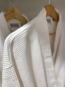 a white shirt hanging on a rack in a closet at Cottage Boutique Apartments Athens in Athens