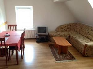 a living room with a couch and a table at Apartmani Lucija in Vrata