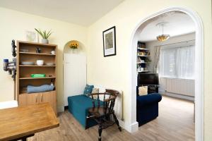 a living room with a blue couch and a table at 3BR house a perfect group getaway in London