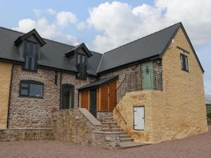 a brick house with a black roof at Palace Studio in Hereford