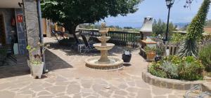 a garden with a fountain and many plants at Casa Ramon B&B in La Esperanza