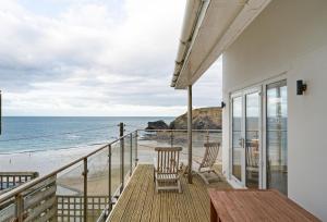 a balcony with chairs and a view of the beach at The Lookout in Portreath