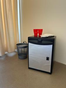a black and white cabinet with two red cups on top at True Man Beach Apartments in Odesa