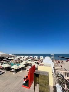 a beach with chairs and umbrellas and the ocean at True Man Beach Apartments in Odesa