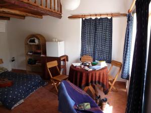 a living room with a table and chairs in a room at Andean Spirit Lodge in Mollepata