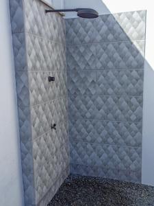 a bathroom with a shower with a glass door at Suítes a 100m da praia e 800m do Beto Carrero in Penha
